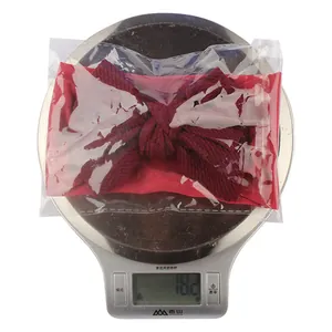 Weight measurement of a red nylon bow baby headband on a scale showing 18.2g details