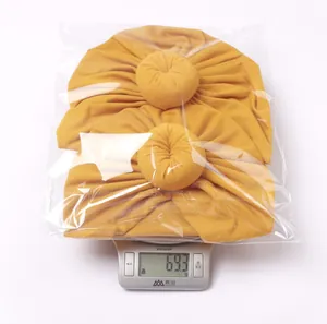 Ginger yellow knitted parent-child donut hat set with weight display on a scale