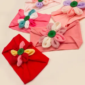 Set di cinque fasce per neonati in nylon colorato con fiori in tessuto fatti a mano