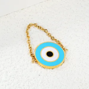 Minimalist stainless steel Evil Eye ring with blue enamel charm on white background