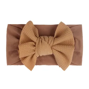 Brown nylon baby headband with a soft elastic waffle knit bow for infants and toddlers