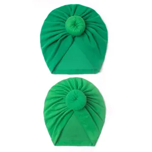Detail of green cotton donut hats for mother and baby with gathered pleat design