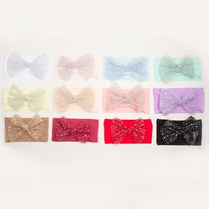 Set of 12 soft nylon baby headbands with large sparkling mesh bows in assorted candy colors