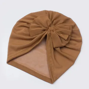 Caramel mesh baby turban hat with a large bow detail for lightweight summer comfort