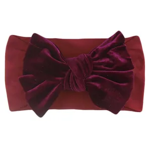 Detailed view of dark burgundy velvet baby headband with a large oversized bow knot