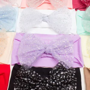 Detail of colorful nylon headbands for babies with sparkly glitter tulle bow knots