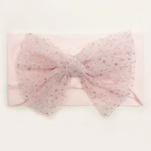Detailed close-up of soft pink nylon headband with a large sequined mesh bow for babies