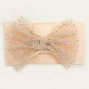 Close-up of soft nylon baby headband with a sequined mesh bow in peach color