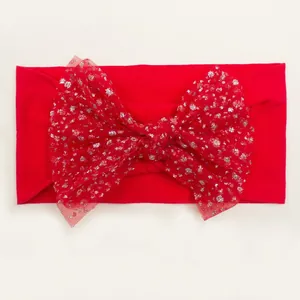 Detail of red baby headband featuring large mesh bow with sparkling silver sequins