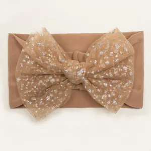 Detailed view of baby nylon headband featuring a large mesh bow with silver sequins
