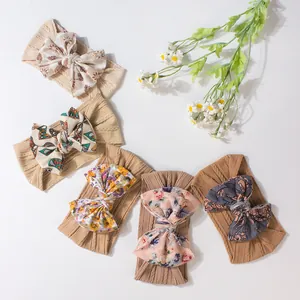 Five-pack of elastic baby headbands with jacquard floral bows in earthy tones