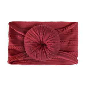 Close-up of wine red ribbed nylon headband with a soft donut knot for infants