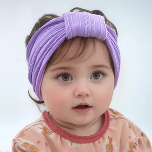 Detail of purple knitted nylon baby headband featuring stretch texture and soft knot