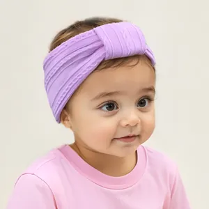 Detail of purple knitted nylon baby headband with cable texture and center knot design