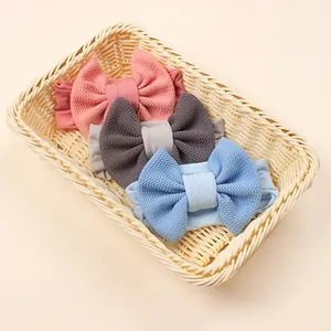 Three pack candy color waffle texture bow headbands for babies in a woven basket