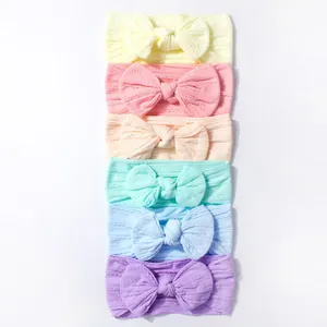 Detail of 6-pack baby nylon headbands with knit texture and large bow in macaron colors