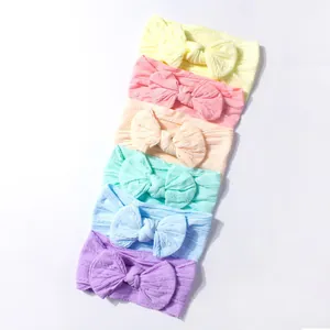 Set of 6 soft nylon baby headbands with large bows in various pastel macaron colors