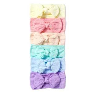 Set of 6 colorful nylon baby headbands with large ribbed knit bows in pastel shades