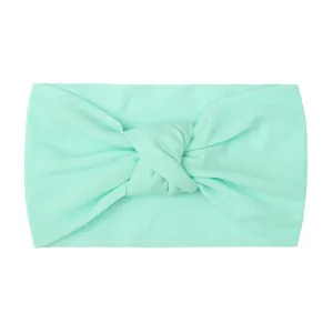 Mint green wide knotted nylon headband for infants with a soft elastic knit texture