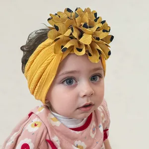 Close-up of yellow jacquard nylon baby headband with a leopard print floral detail
