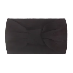 Detail showing the soft fabric texture and central twist of this black nylon baby headband