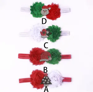 Close-up of baby Christmas headbands with rhinestone Santa and festive flower details