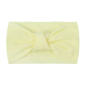 Detail shot of soft cream yellow knotted nylon headband with ribbed texture for babies