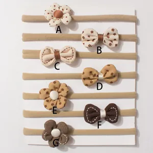 Set of 7 baby nylon headbands with cute bows and floral designs in warm earth tones