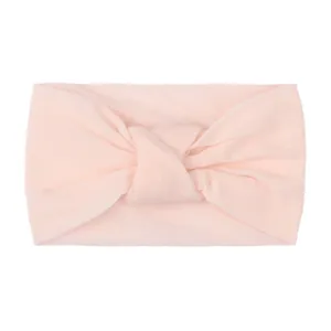 Detail view of baby knot headband in soft light pink nylon with a wide-brim design