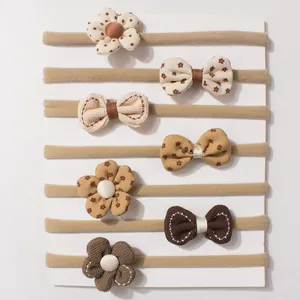 Set of 7 baby nylon headbands with cute bows and flowers in earthy warm tones