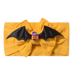 Cute Halloween baby headband with orange bow, black bat wings and pumpkin witch charm