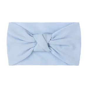 Close-up of light blue knotted baby headband made of soft nylon fabric texture