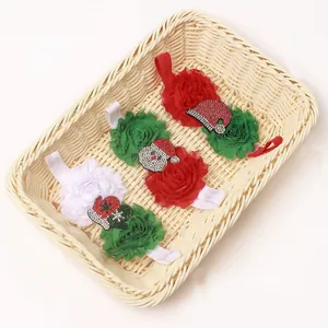 Detail of baby Christmas headbands with fabric flowers and Santa Claus motifs in basket