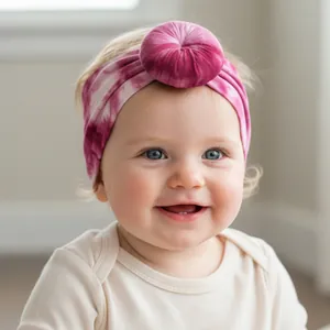 Detail of baby donut headband with magenta tie-dye texture and soft elastic fabric