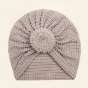 Detail of soft purple waffle knit texture and circular floral knot on baby turban hat