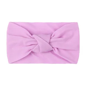 Detail of pink knotted baby headband made of soft elastic fabric for newborns