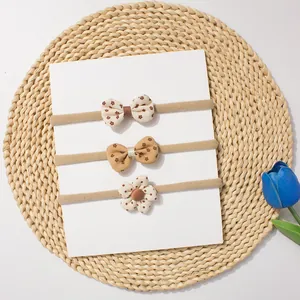 Detailed set of three baby headbands featuring floral bows and a 3D dotted flower design