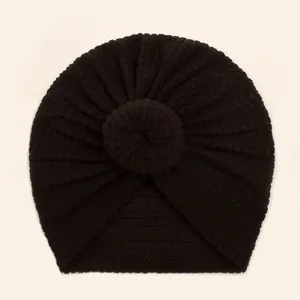 Detail view of baby waffle knit turban hat with central donut knot in dark coffee color