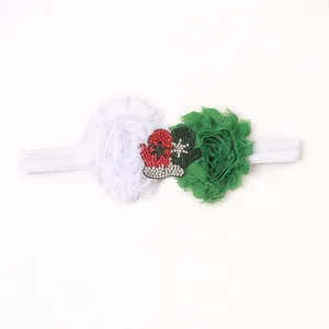 Detail of Christmas baby headband with chiffon flowers and sequined holiday glove patches