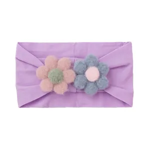 Detailed view of elastic nylon baby headband with 3D plush flowers and soft knit fabric