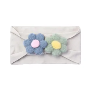 Detailed view of elastic nylon baby headband with soft plush flowers and knit texture
