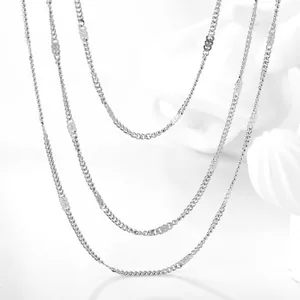Minimalist silver multi-layered chain necklace featuring polished flat metal sequin accents