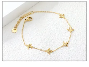 Macro shot of 18k gold plated stainless steel bracelet with five airplane-shaped charms