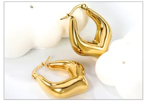 Detailed view of 18k gold plated U-shaped earrings with a polished mirror finish