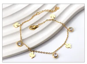 Close-up of 18K gold plated anklet with cactus charms and sparkling cubic zirconia stones