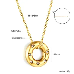 Detalle del colgante donut de acero inoxidable bañado en oro 18k con diamantes blancos