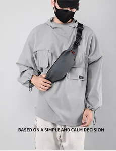 Detail view of dark grey waterproof chest bag showing durable buckle and adjustable strap