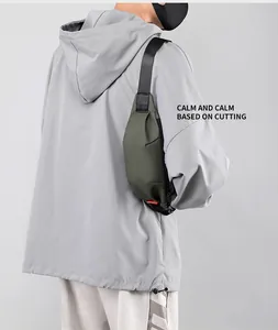 Close-up of military green waterproof chest bag with adjustable strap and red detail tag