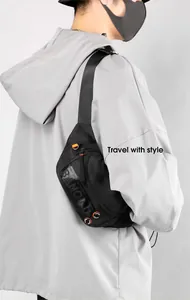 Close-up of waterproof black crossbody bag with orange accents and adjustable strap
