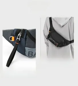 Detail of multi-compartment navy and grey chest bag with smooth zippers and neon accents